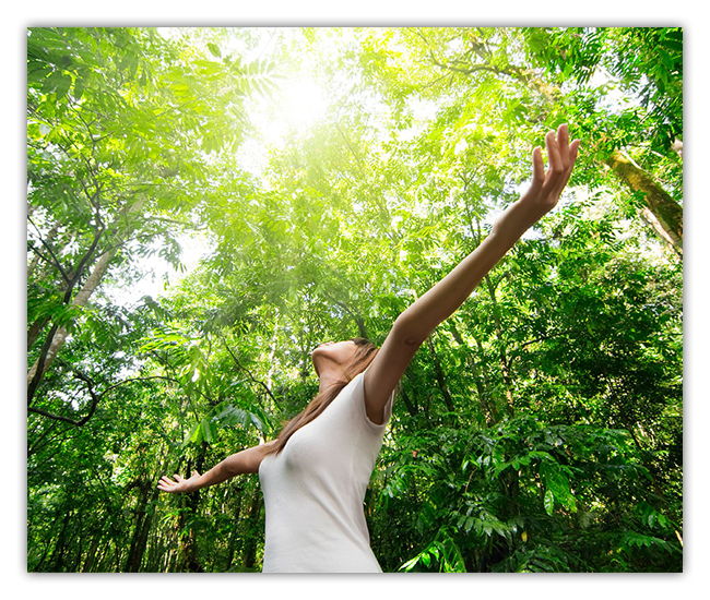 woman in forest outstretched arms