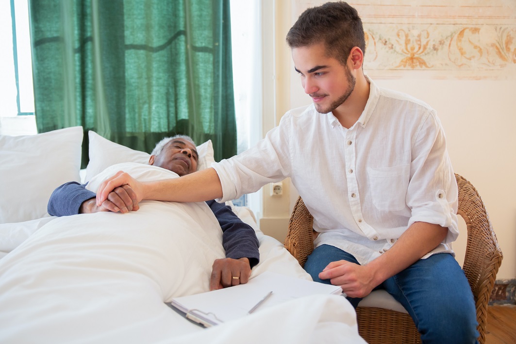 caregiver with elderly patient at home